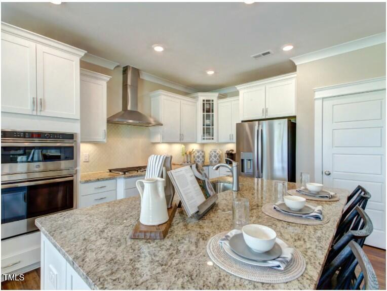 0 Boykin Road Sims, NC 27880 - Photo 11 of 48 a kitchen with granite countertop a refrigerator a stove a sink a dining table and chairs