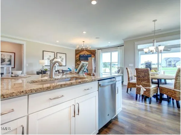a kitchen with counter space dining table and chairs