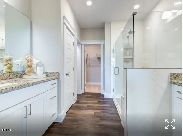 a bathroom with a granite countertop sink a shower and a mirror