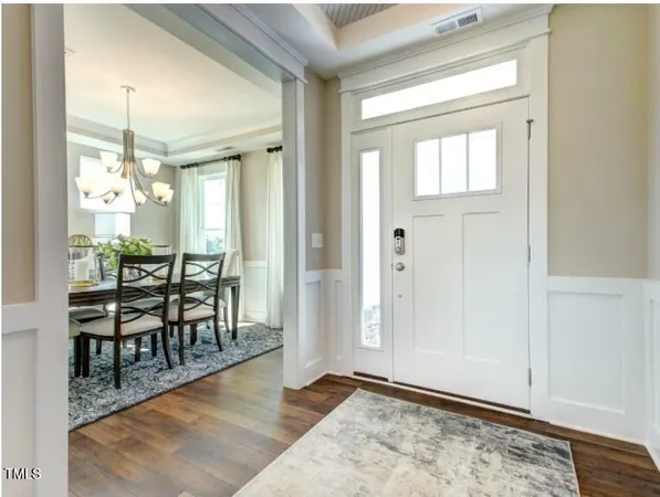 a view of a dining room with furniture and chandelier