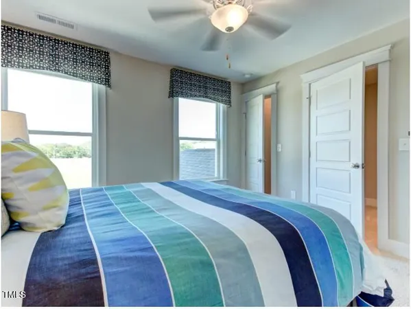 a bedroom with a large bed and a window