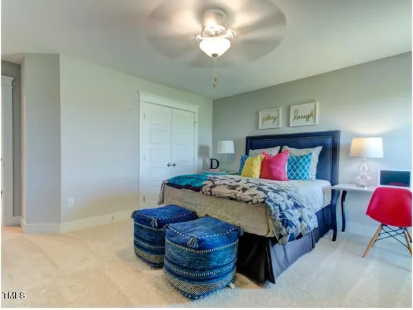 a bedroom with bed and a chandelier