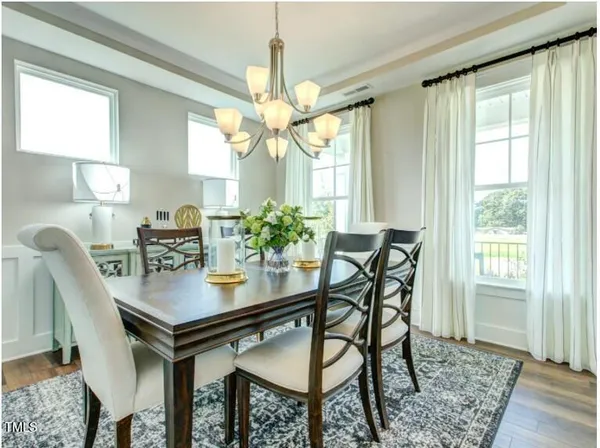 a view of a dining room with furniture and a chandelier