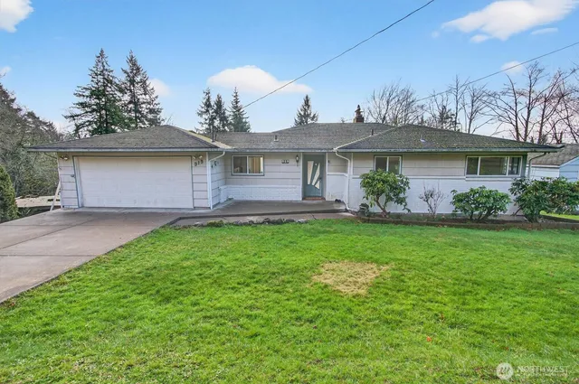 a front view of house with yard and green space