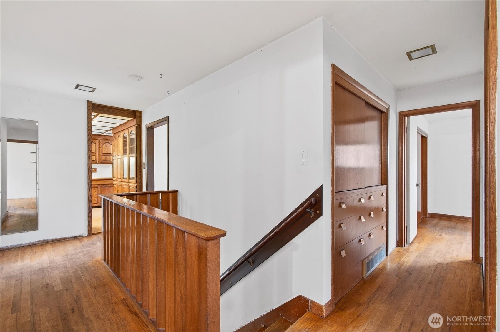 919 Cascade Drive Longview, WA 98632 - Photo 17 of 31 a view of hallway with wooden floor and stairs