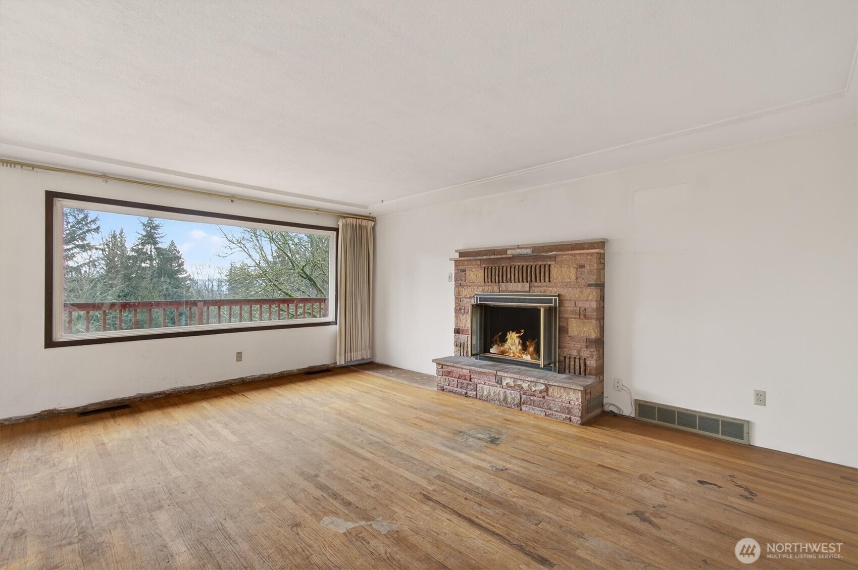 919 Cascade Drive Longview, WA 98632 - Photo 4 of 31 a view of an empty room with a fireplace and a window