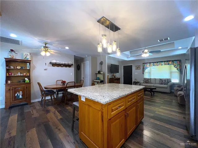 a view of kitchen island with granite countertop living room
