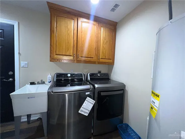 a kitchen with appliances cabinets and a table