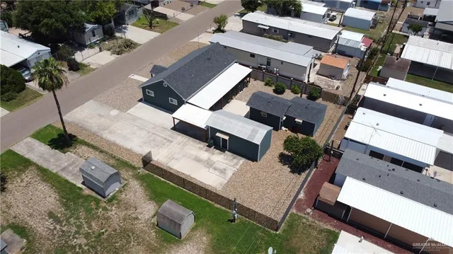 an aerial view of a house with garden space and street view