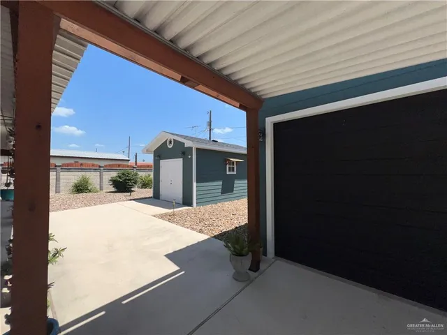 a view of a porch with a table and chairs