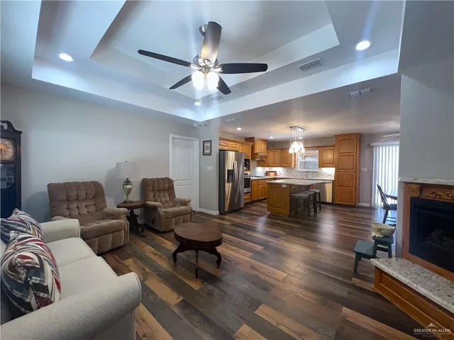 a living room with fireplace furniture and a flat screen tv