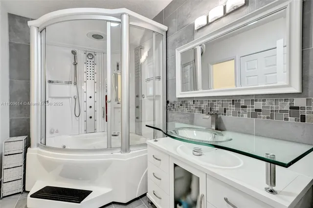 a bathroom with a sink mirror toilet and shower