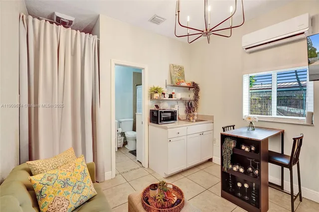a view of a patio with couches table and chairs under an umbrella