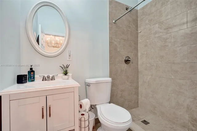 a front view of house with yard and trees in the background