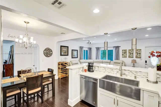 a living room with stainless steel appliances kitchen island granite countertop furniture and a kitchen view