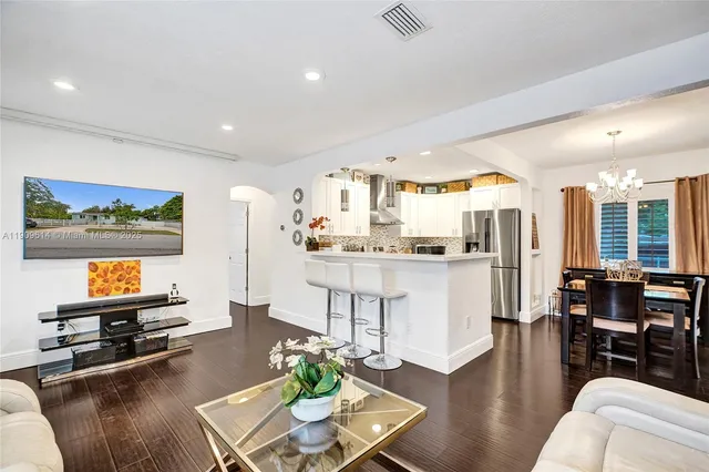 a view of a dining room with furniture and wooden floor
