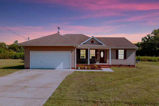 a front view of a house with swing and table