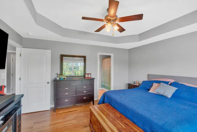 a bedroom with a bed and a flat tv screen on dresser