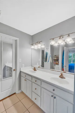 a spacious bathroom with a double vanity sink mirror and