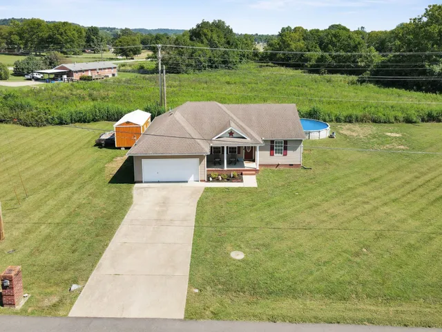 a front view of a house with a yard table and chairs