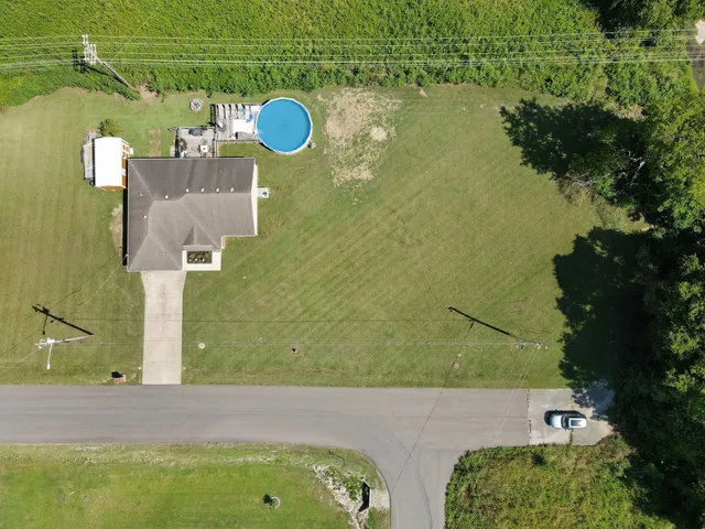 an aerial view of a house with a swimming pool