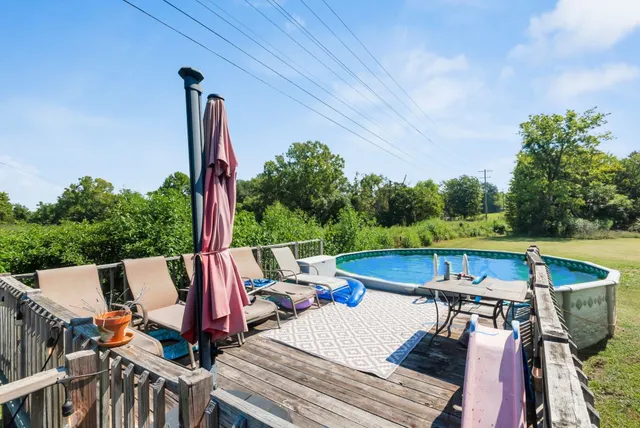 swimming pool view with a seating space