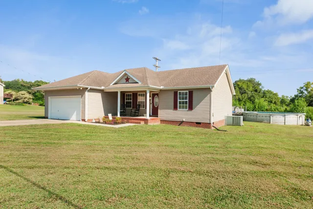 a front view of a house with a garden