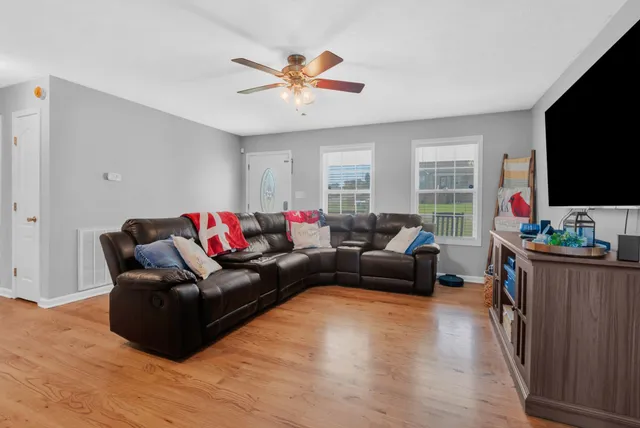 a living room with furniture and a flat screen tv