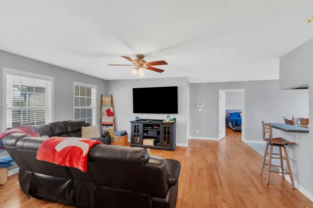 a living room with furniture and a flat screen tv