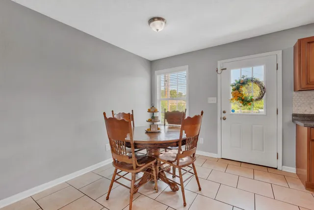 a view of a dining room with furniture and a window