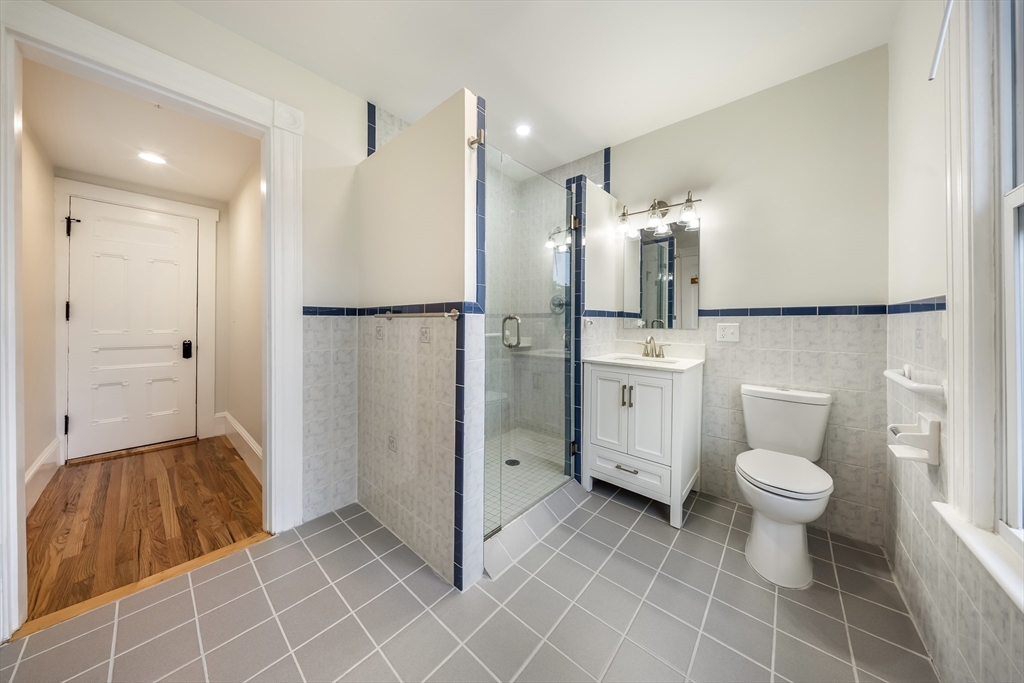 180 Jackson Street, Unit B Lawrence, MA 01841 - Photo 7 of 8 a bathroom with a sink a toilet and shower