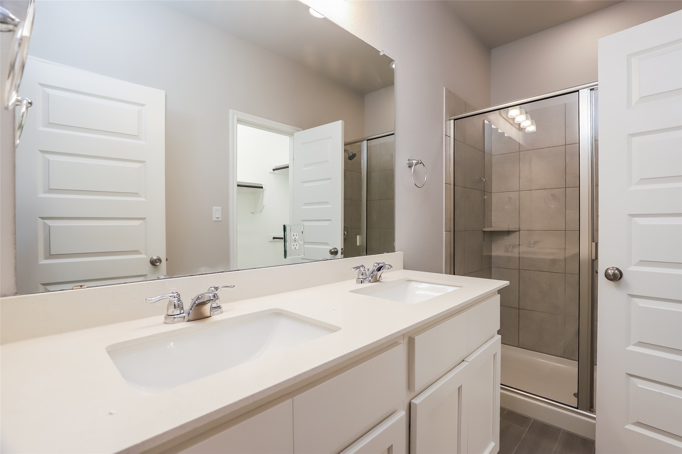 2724 Juniper Woods Road Leander, TX 78641 - Photo 11 of 21 Double vanities and a tiled walk-in shower elevate this contemporary bathroom space.