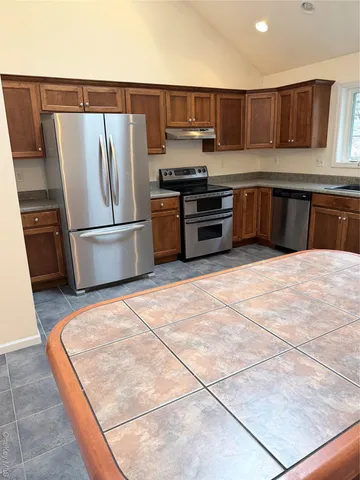 a kitchen with a sink a counter top space and appliances
