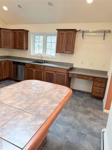 a kitchen with stainless steel appliances granite countertop a stove a sink a microwave and a refrigerator
