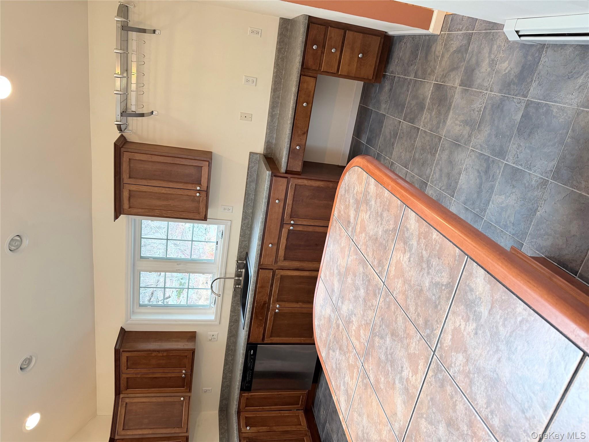 1043 Roosa Gap Road Pine Bush, NY 12566 - Photo 12 of 20 Kitchen with recessed lighting, dishwasher, dark countertops, and brown cabinetry