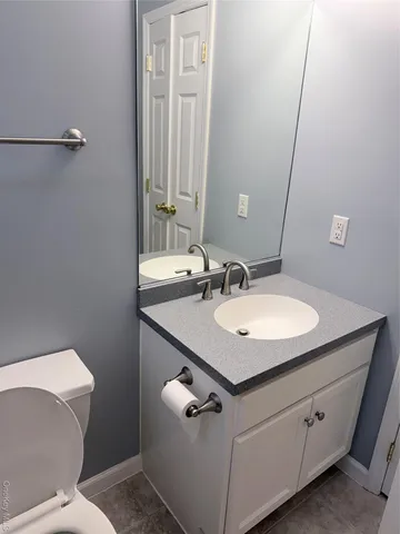 a white toilet sitting next to a shower curtain