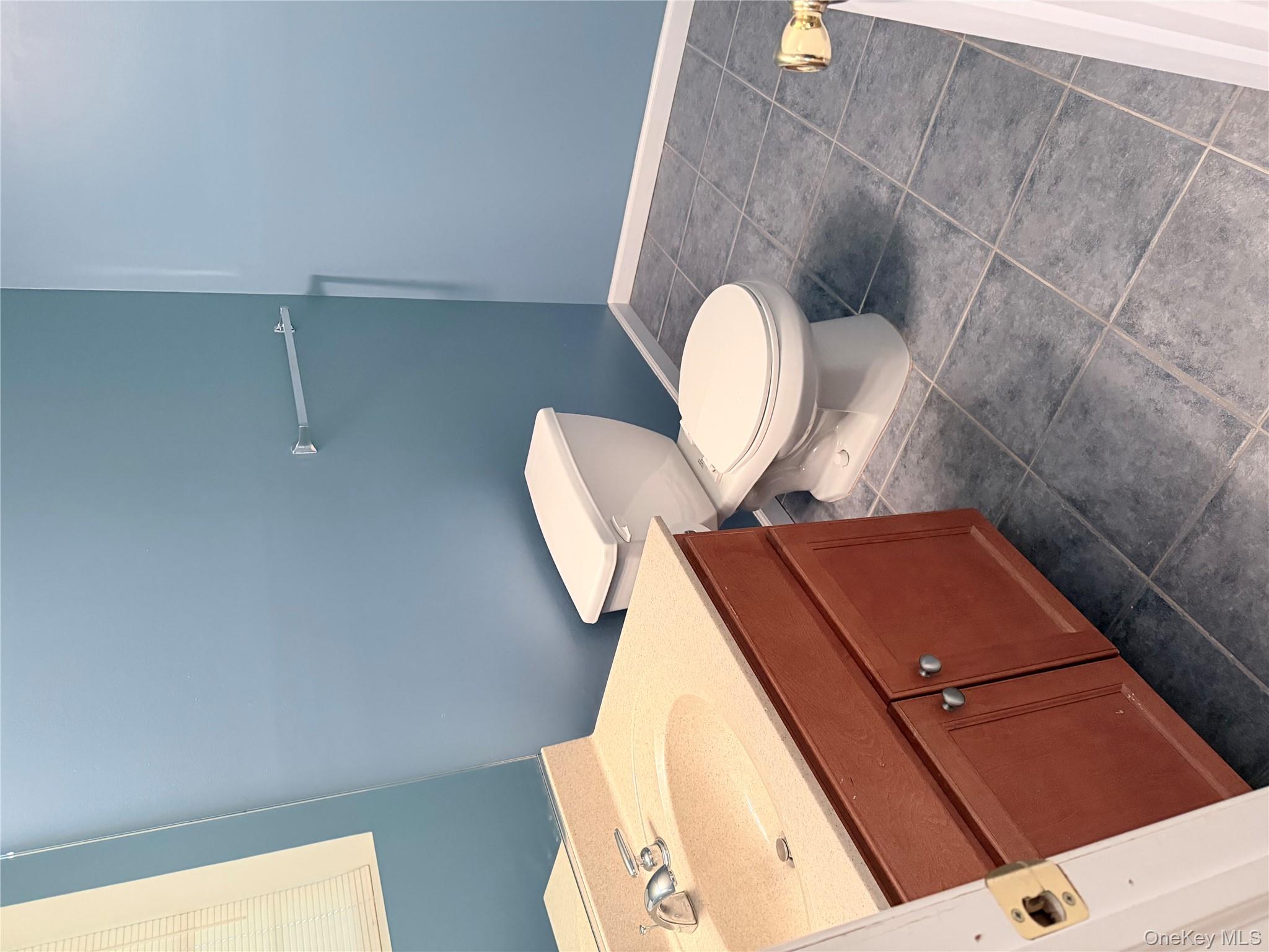 1043 Roosa Gap Road Pine Bush, NY 12566 - Photo 7 of 20 Bathroom with vanity and dark tile patterned floors