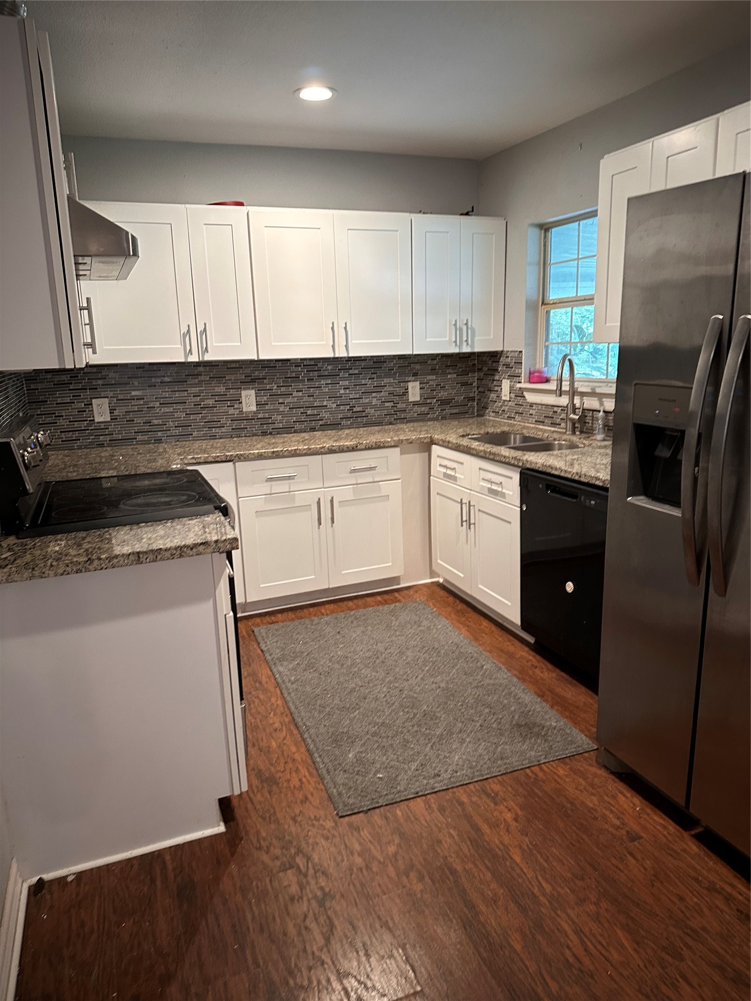 4802 Eppes Street Houston, TX 77021 - Photo 5 of 34 a kitchen with a refrigerator sink and cabinets