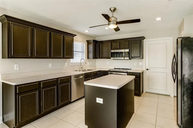a kitchen with a sink stove and microwave