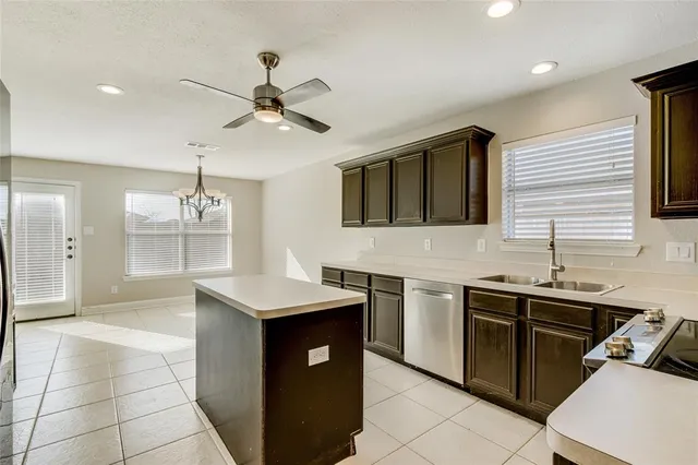 a kitchen with a sink a stove and cabinets