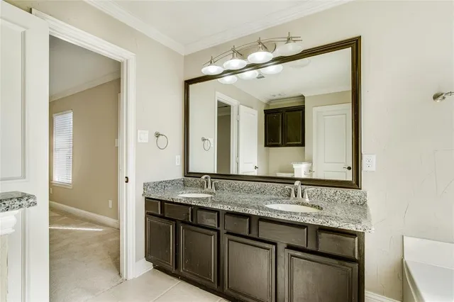 a bathroom with a granite countertop sink vanity and mirror