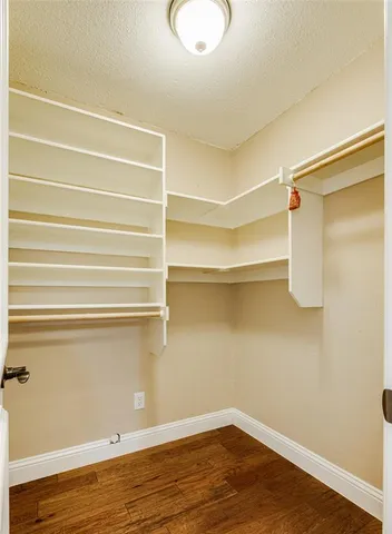 a view of a room with wooden floor and cabinet