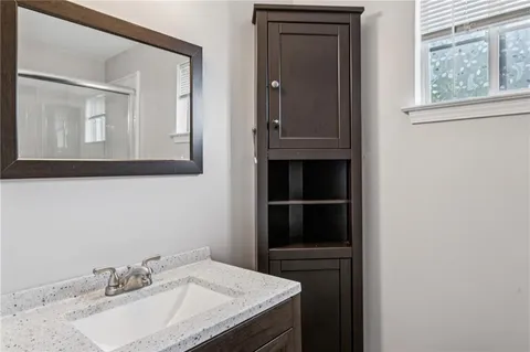 a bathroom with a sink vanity and a mirror