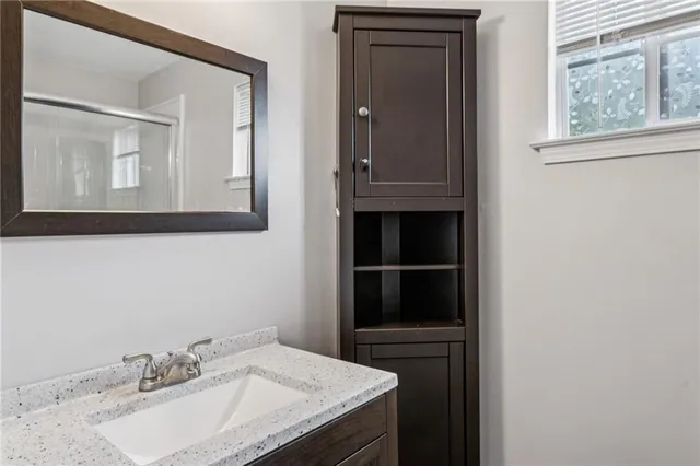 a bathroom with a sink vanity and a mirror