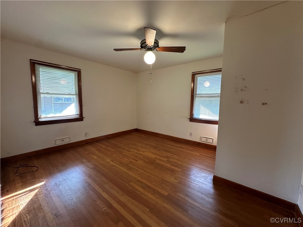 3415 Virginia Street Hopewell, VA 23860 - Photo 13 of 24 an empty room with wooden floor cabinet and windows