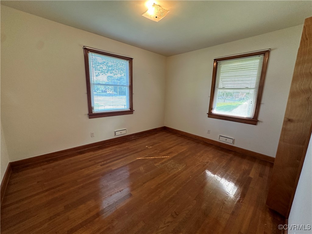 3415 Virginia Street Hopewell, VA 23860 - Photo 16 of 24 a view of an empty room with wooden floor and a window