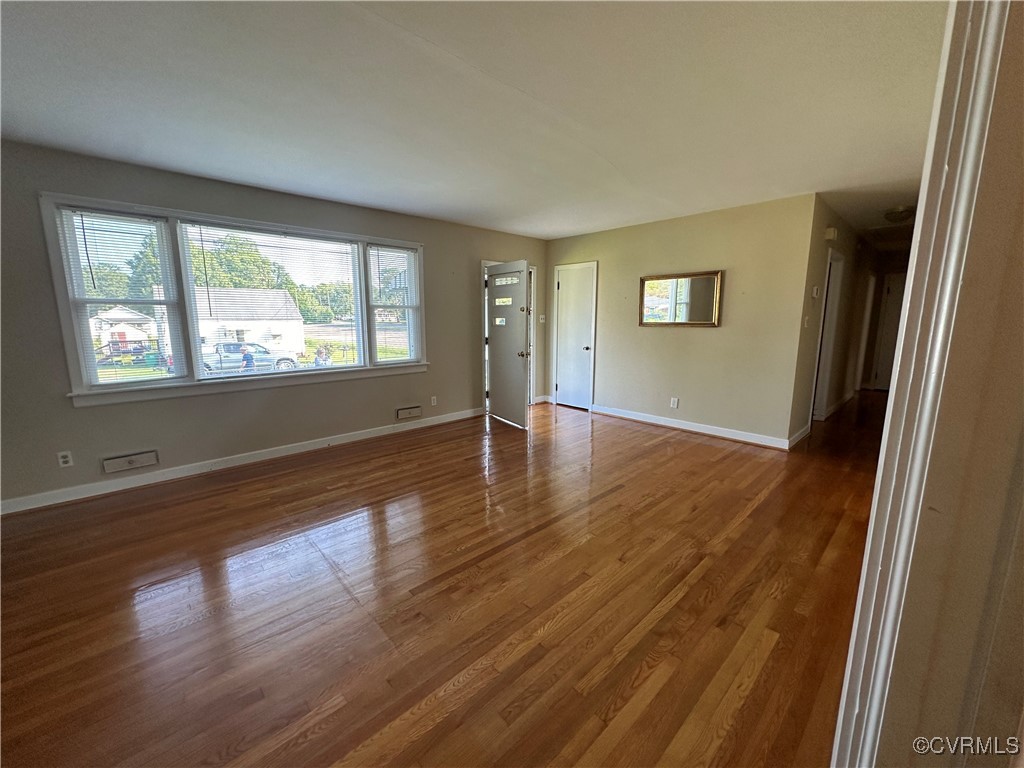 3415 Virginia Street Hopewell, VA 23860 - Photo 3 of 24 a view of an empty room with wooden floor and a window