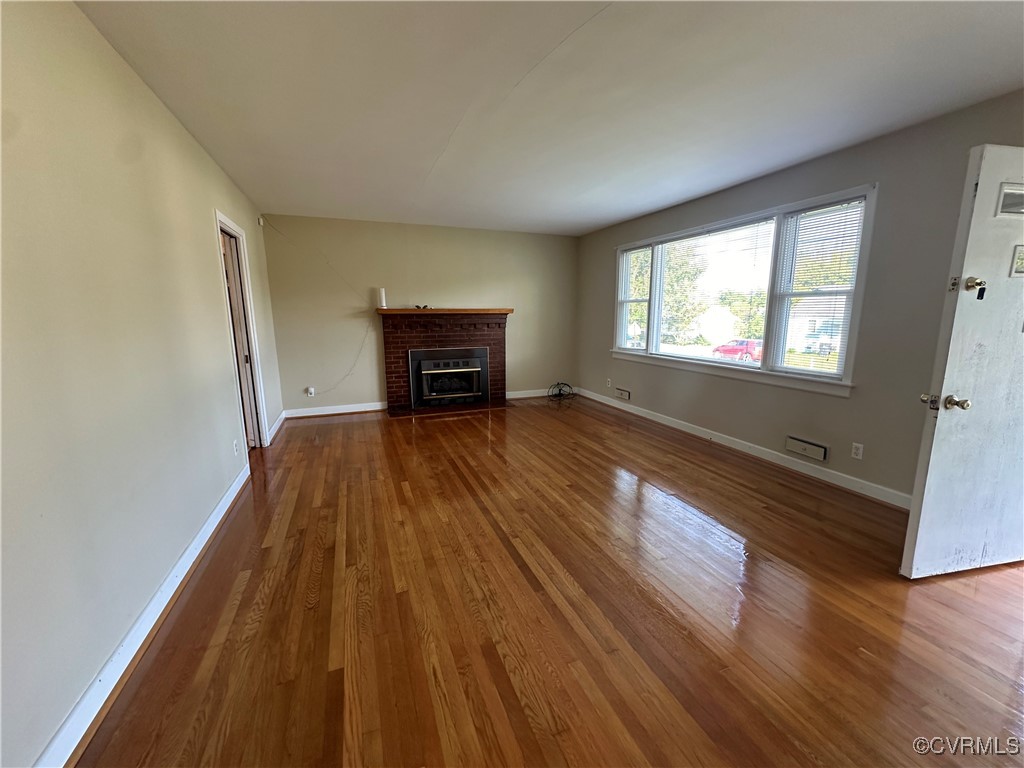 3415 Virginia Street Hopewell, VA 23860 - Photo 4 of 24 wooden floor in an empty room with a window