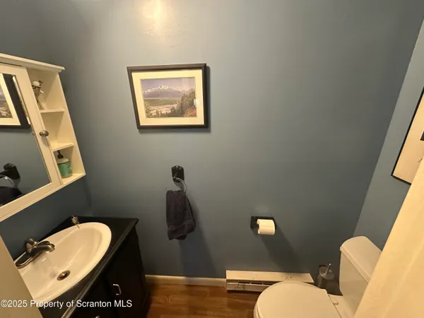 a bathroom with a toilet a sink and mirror