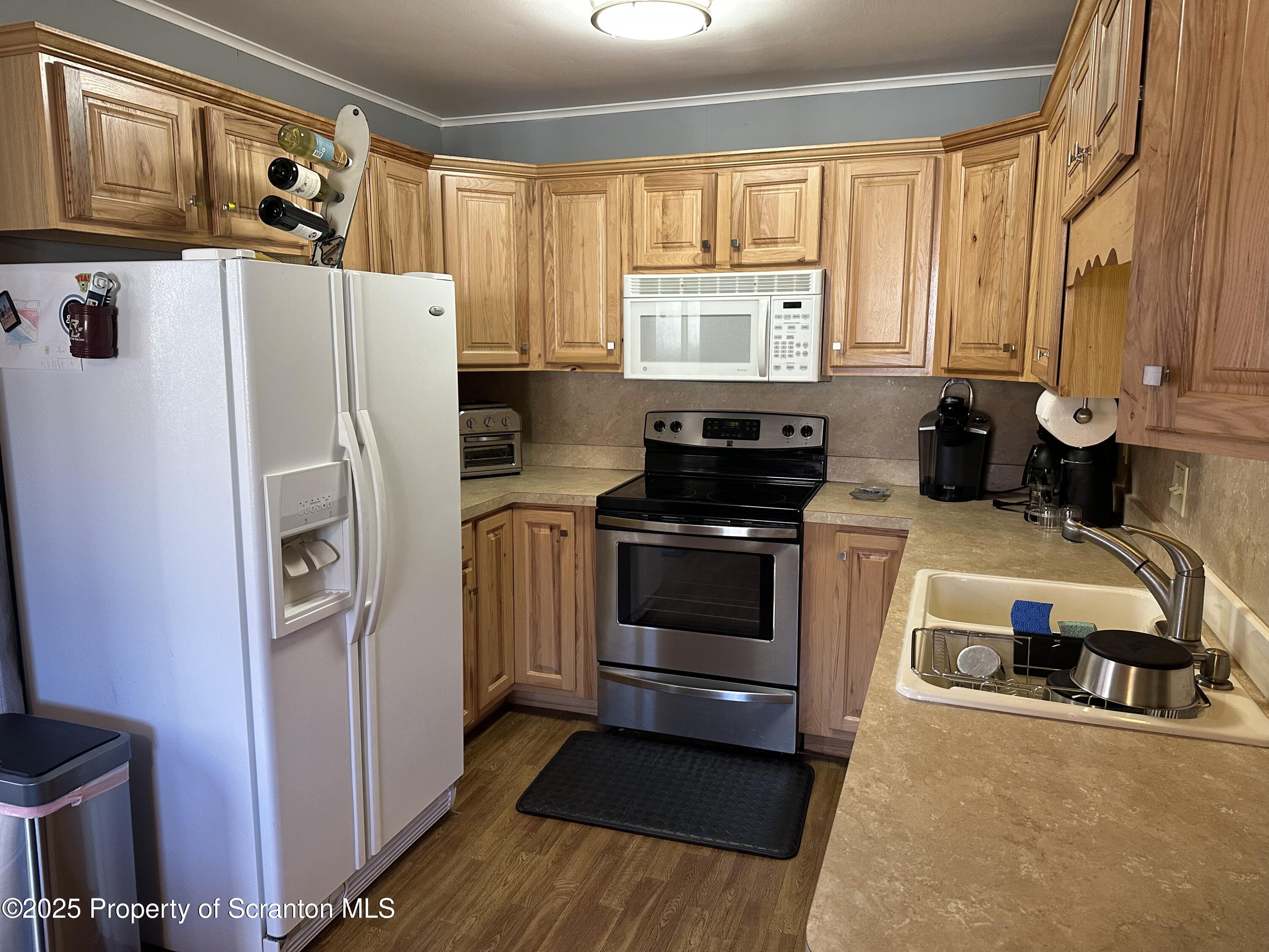 R-1 Ralph Lomma Way Union Dale, PA 18470 - Photo 16 of 25 a kitchen with stainless steel appliances granite countertop a refrigerator a stove a sink and a microwave oven